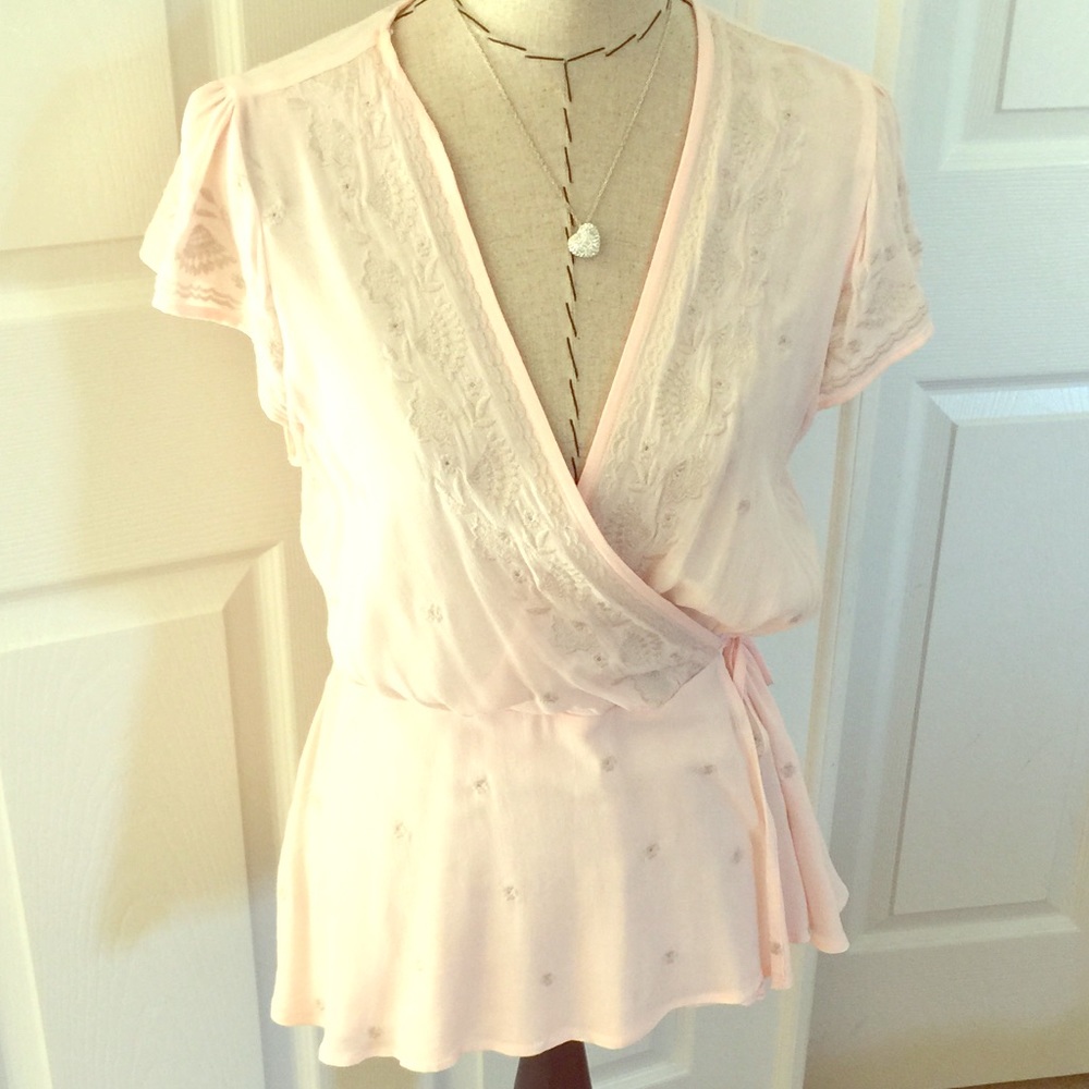 Gorgeous light pink blouse with flower accents